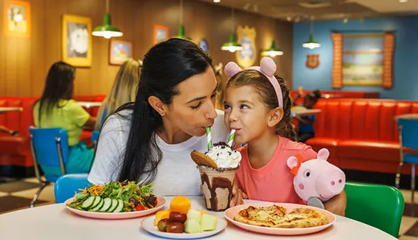 Mother and daughter eat at the Diner Restaurant in Peppa Pig Park Germany